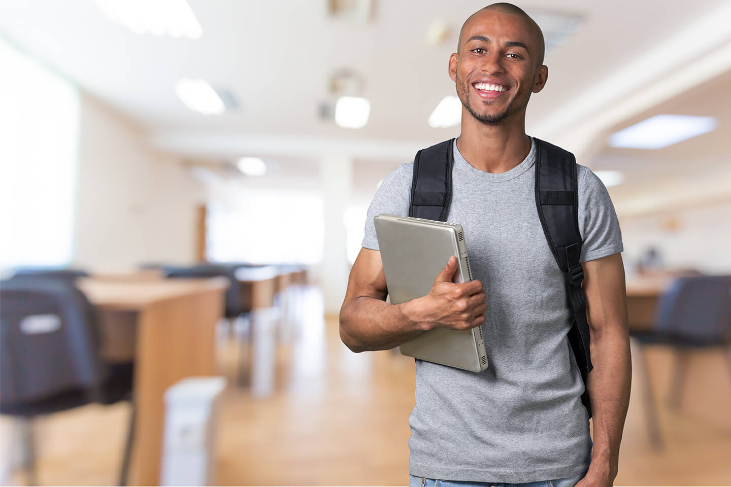 Student with backpack and laptop